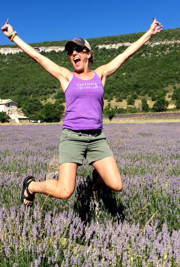 Angela Lahman jumping in lavender field- Young Living Essential Oils